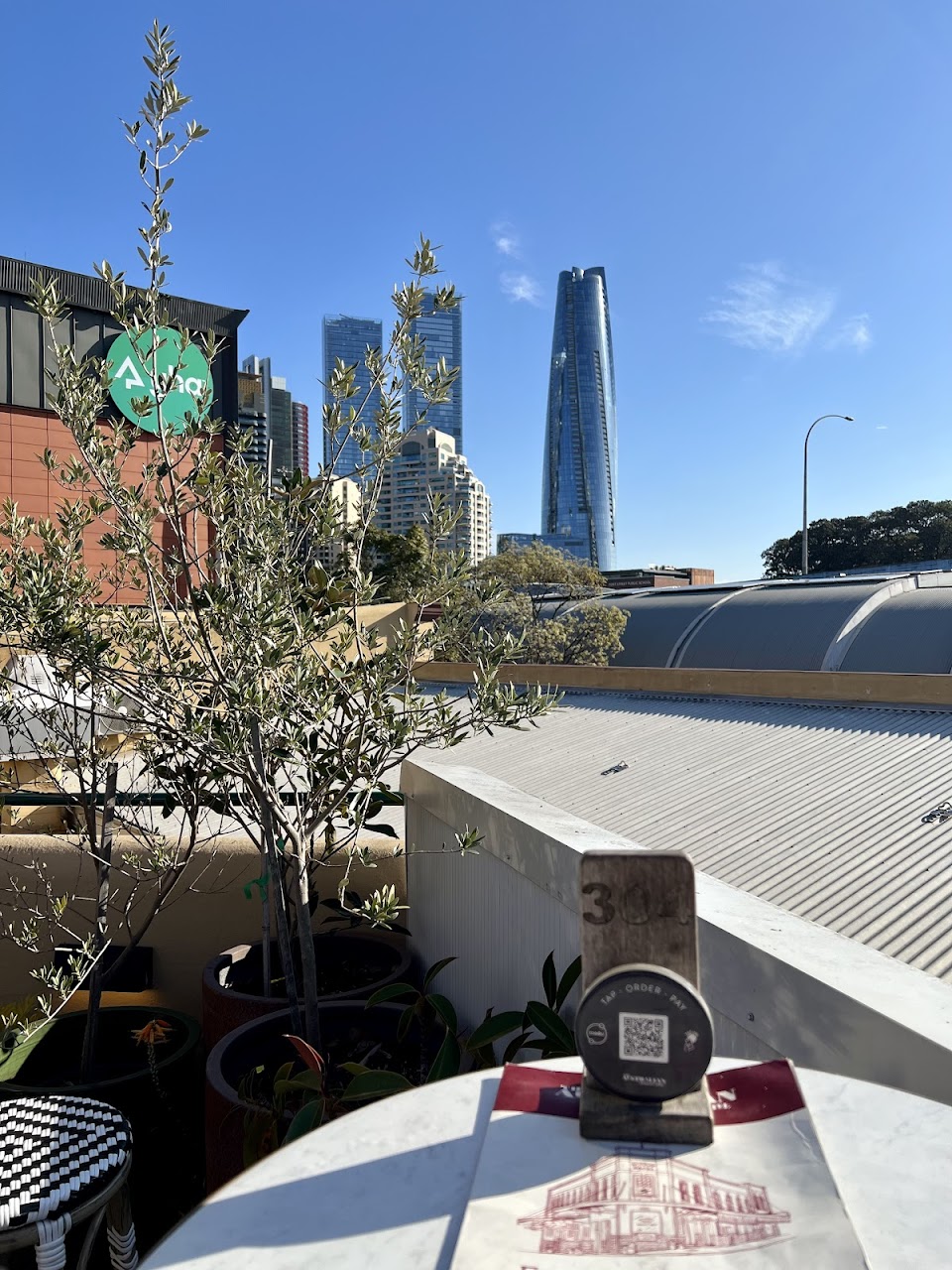 Rooftop table at The Australian Heritage Hotel with Sydney skyline nearby